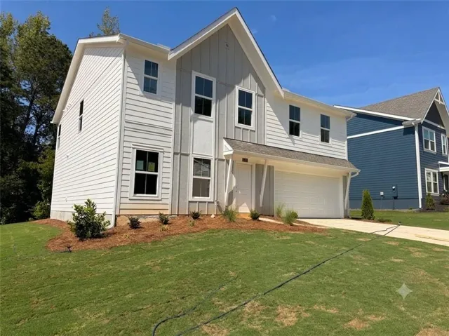 Modern two-story residence featuring a combination of horizontal siding and vertical board and batten accents