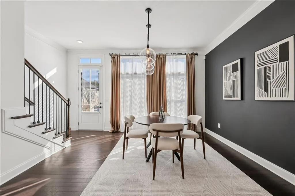 Dining room featuring crown molding and dark wood finished floors