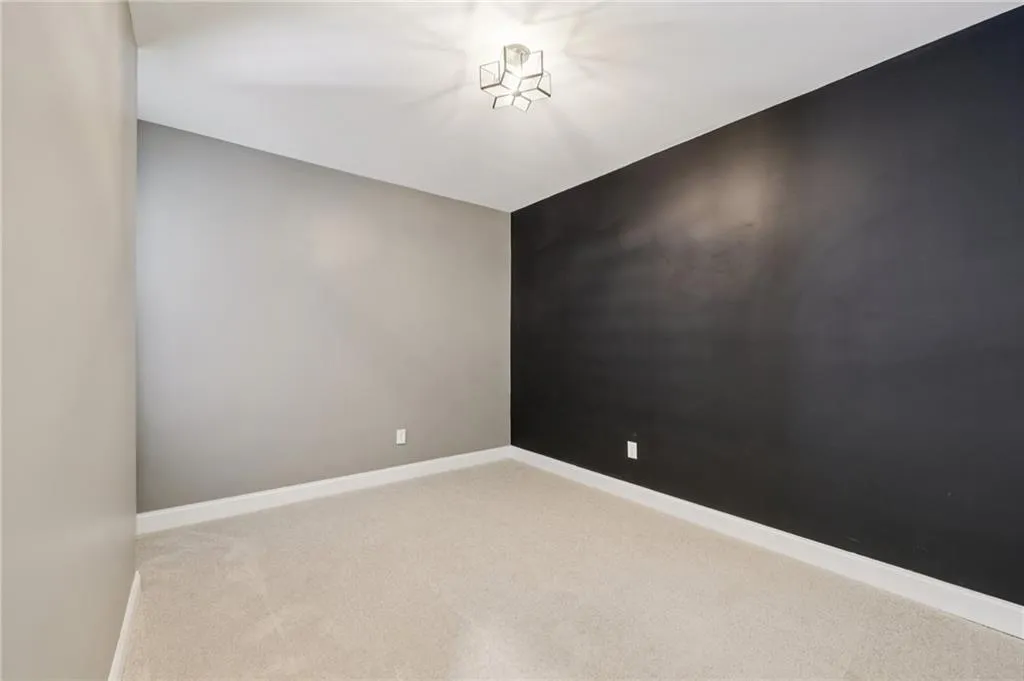 Carpeted spare room with baseboards