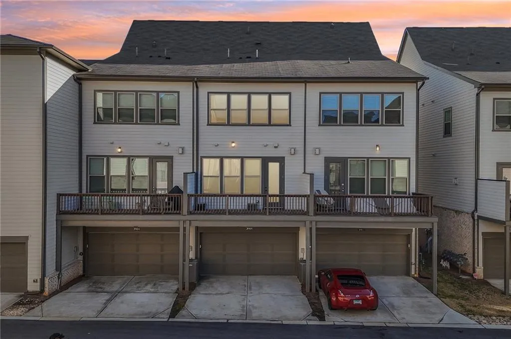 View of front facade featuring brick siding and a balcony