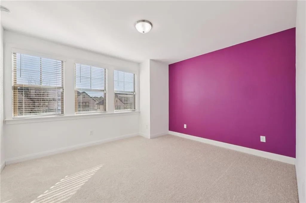 Carpeted empty room featuring baseboards