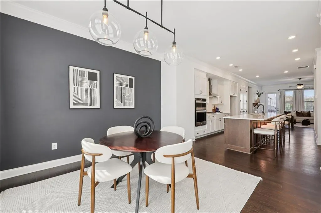 Dining room featuring ornamental molding, dark wood-type flooring, recessed lighting, and a ceiling fan