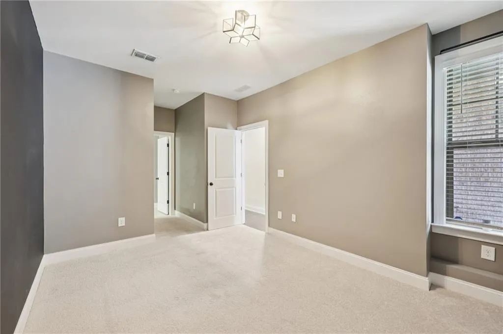 Unfurnished bedroom featuring carpet flooring and baseboards