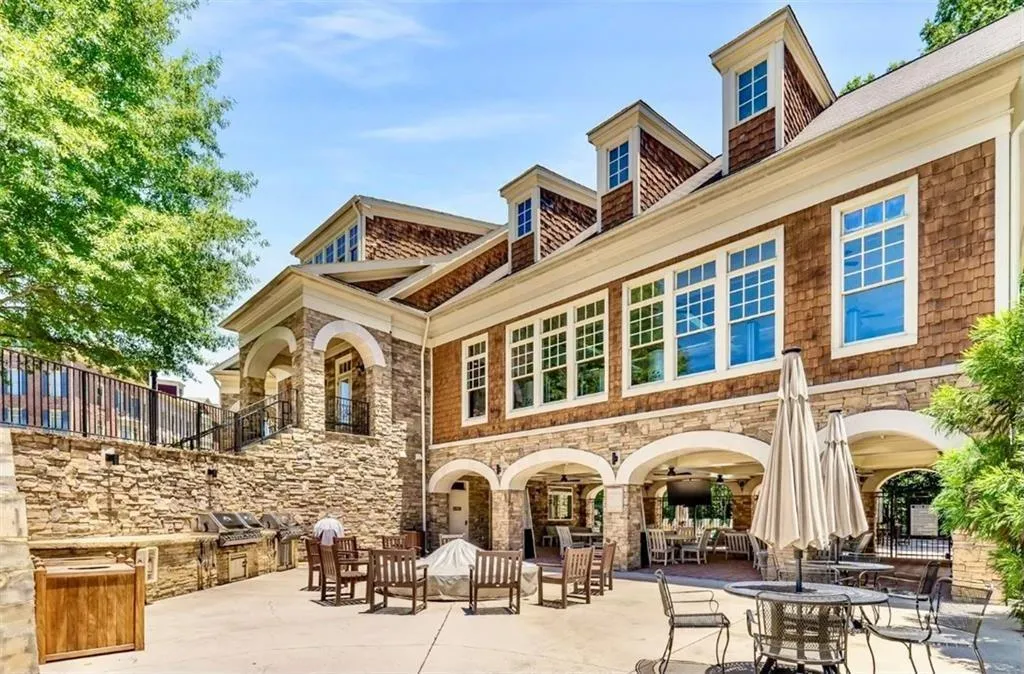 Back of property featuring a patio and stone siding