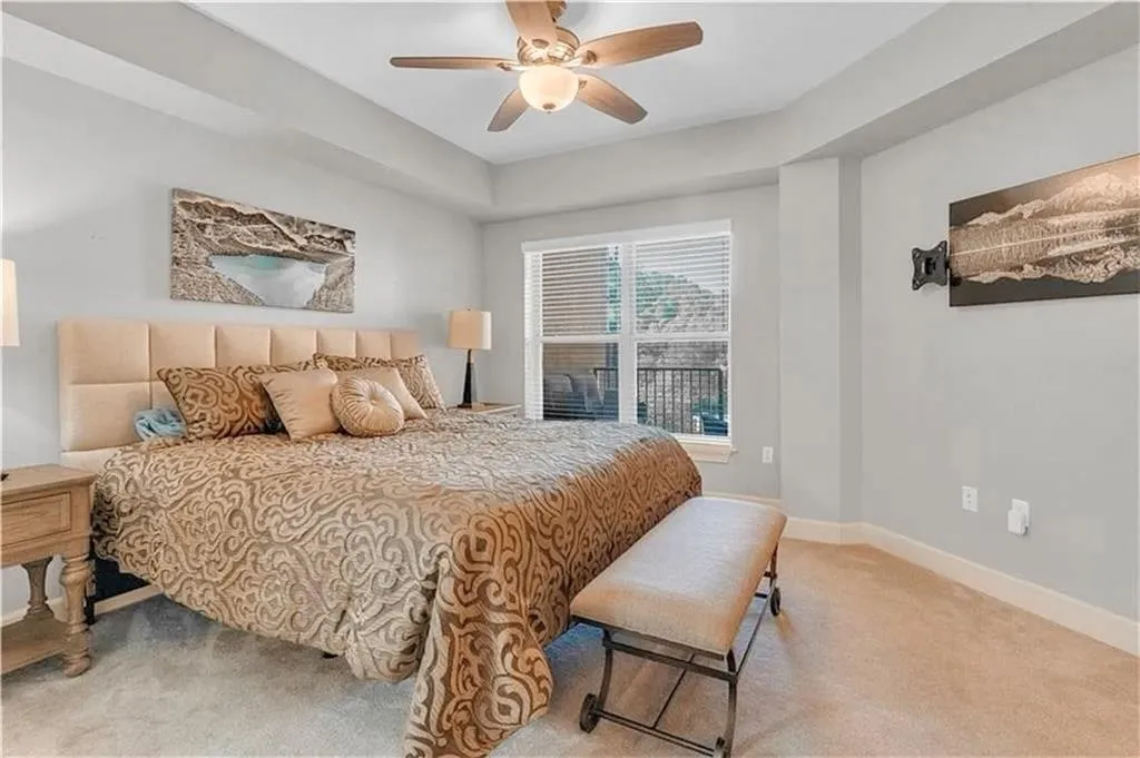 Bedroom featuring light colored carpet and ceiling fan