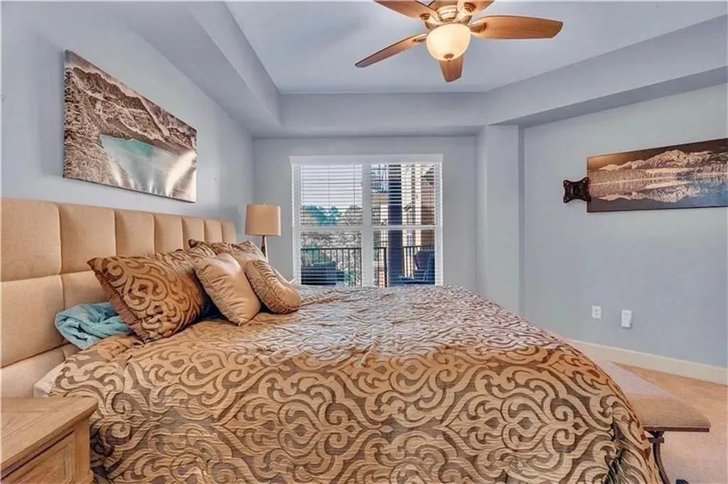 Carpeted bedroom with baseboards and a ceiling fan