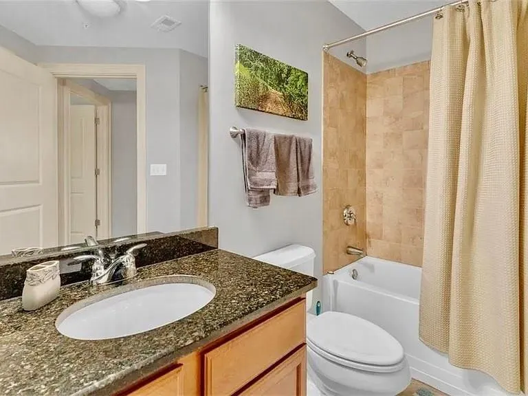 Bathroom featuring shower / bath combo and vanity