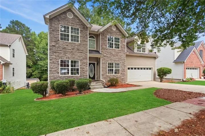 Two-story facade with stone veneer and siding accents