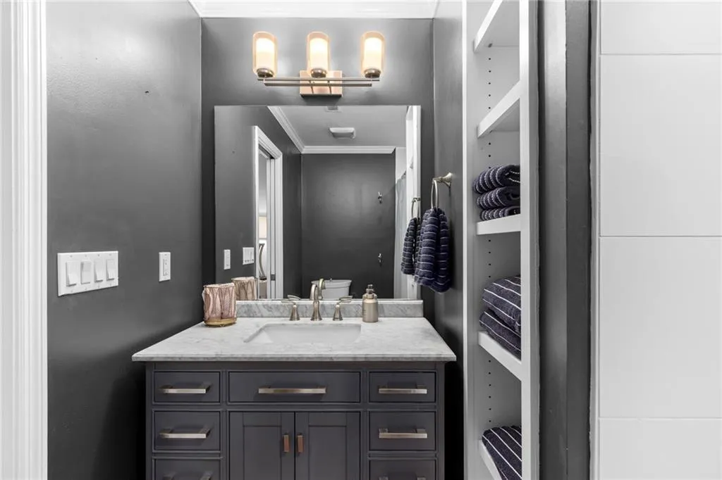 Bathroom with ornamental molding and vanity