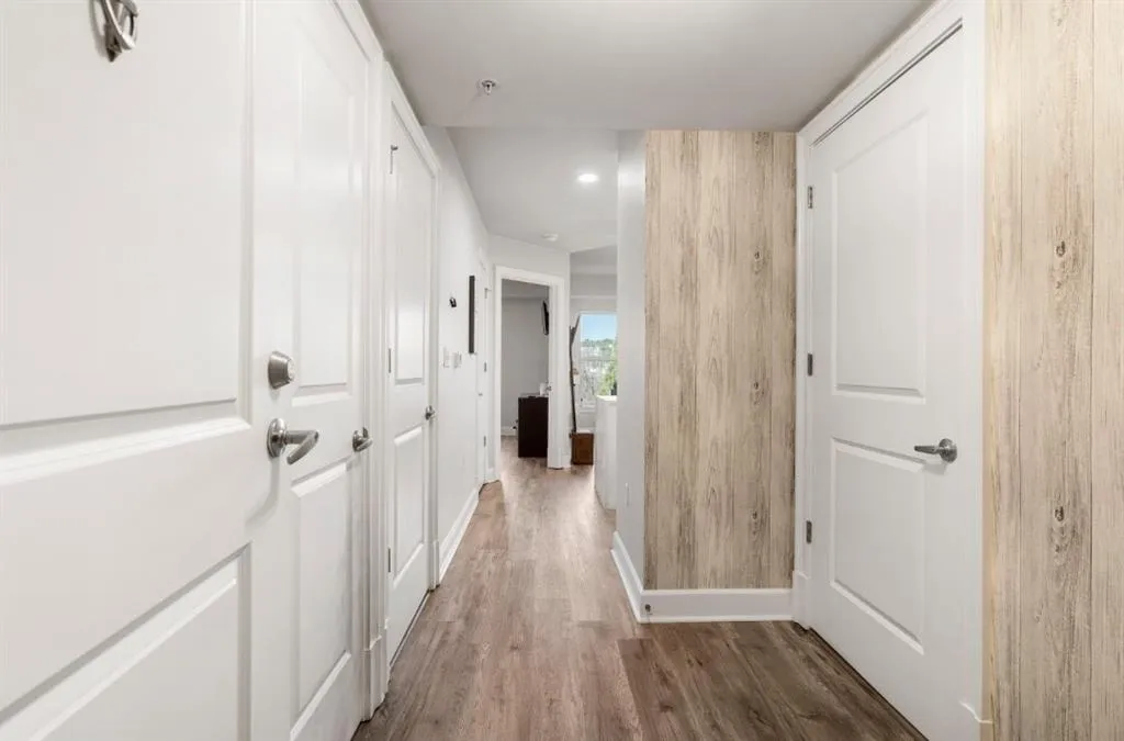 Hall with baseboards and wood finished floors