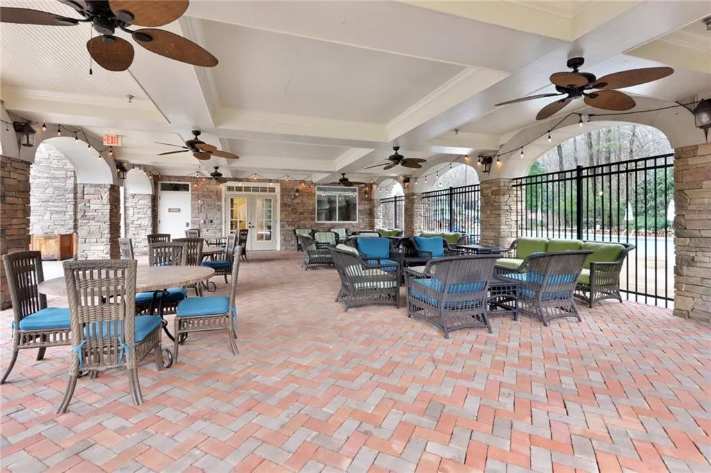 View of patio / terrace with a ceiling fan, fence, an outdoor living space, outdoor dining area, and french doors