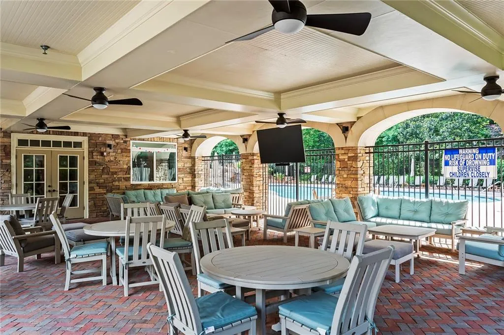 View of patio / terrace featuring fence, french doors, outdoor lounge area, a community pool, and outdoor dining space