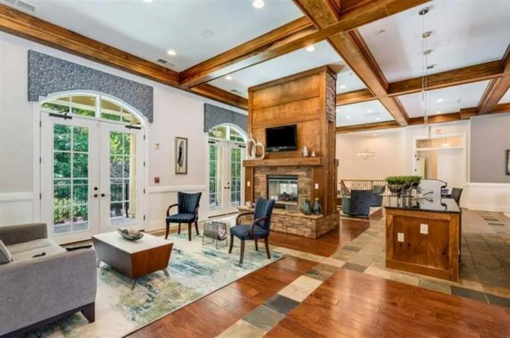 Living area featuring beam ceiling, french doors, coffered ceiling, and hardwood / wood-style flooring