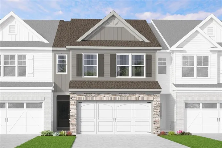 Townhome exterior featuring stacked stone, board and batten siding, and architectural shingles
