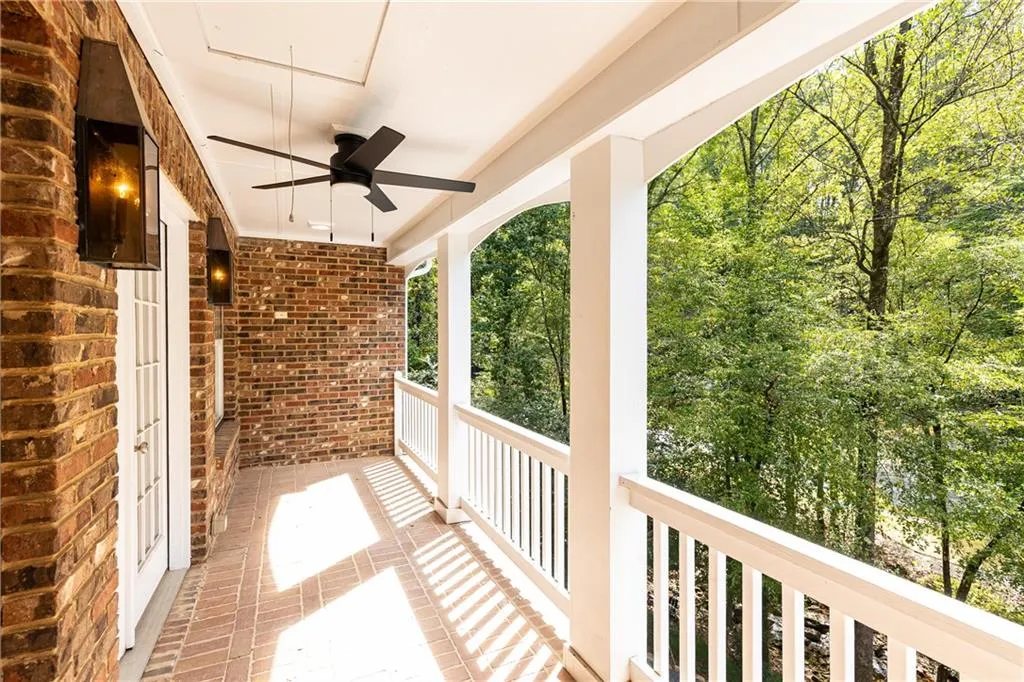Primary suite private balcony with ceiling fan... a greta place to read,enjoy coffee ,  or relax with nature