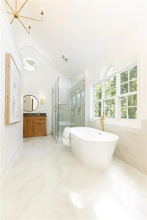 Primary bathroom also has vaulted ceilings.