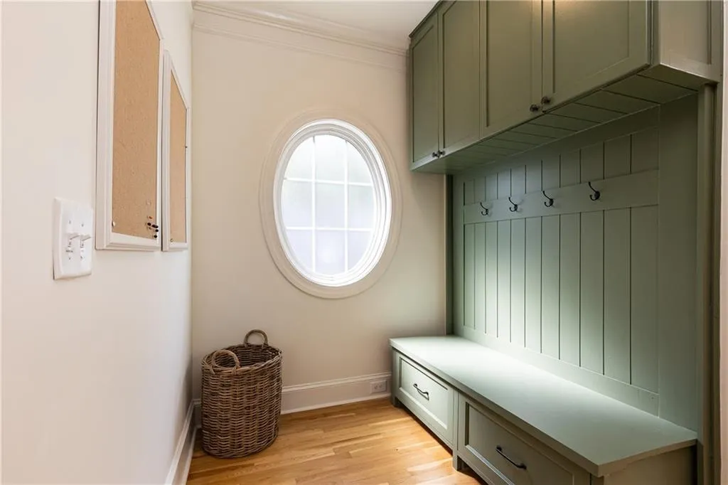 Circular window accent lets in light to the mudroom area