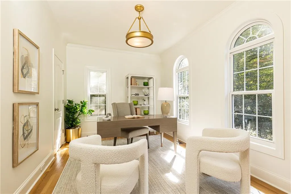 Main level bedroom shown here as an office.  Room has bathroom access and a walk in closet.  Beautiful tall windows give this room light