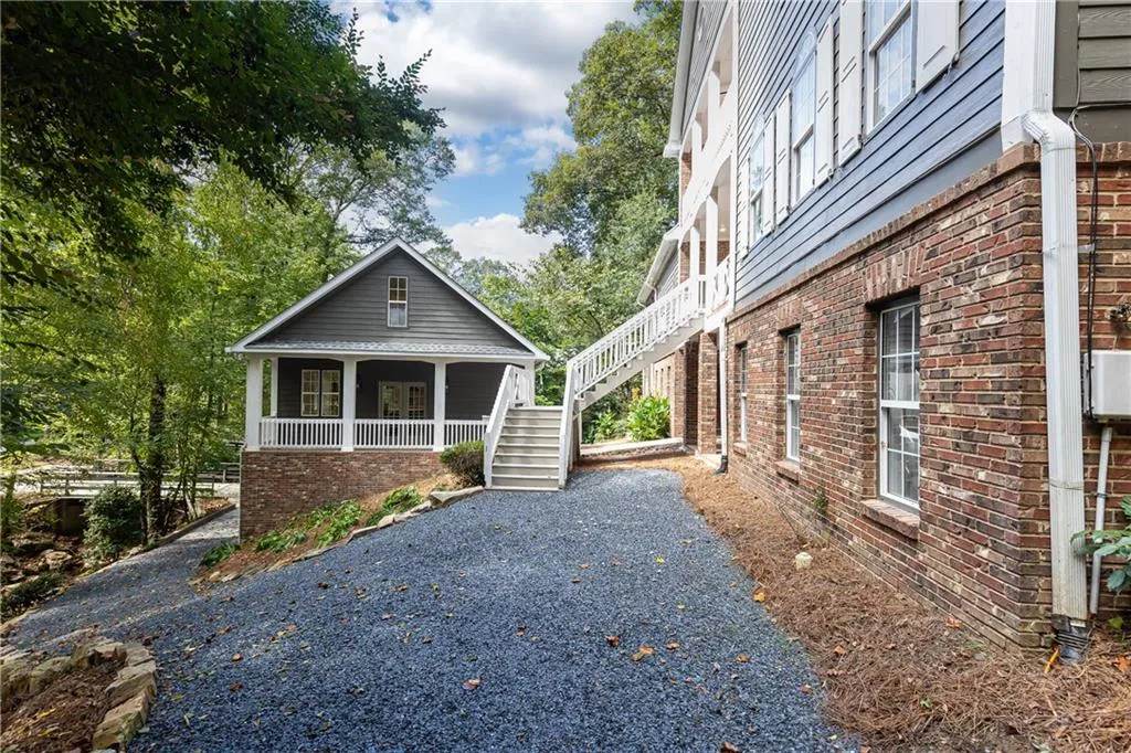 chipped slate drive for easy access to main level of house and carriage house with a pull around and parking pad