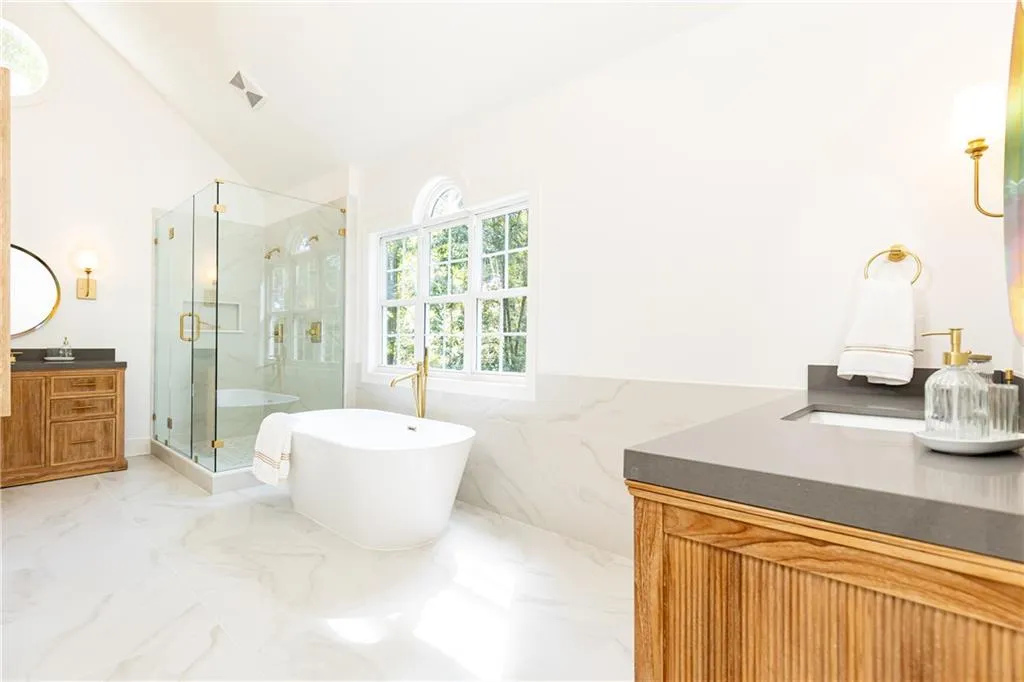 Dual sinks are made of solid reeded wood and have plenty of storage drawers.