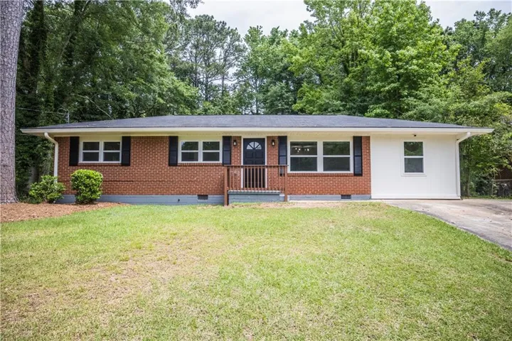 Brick and white siding exterior with dark shutters