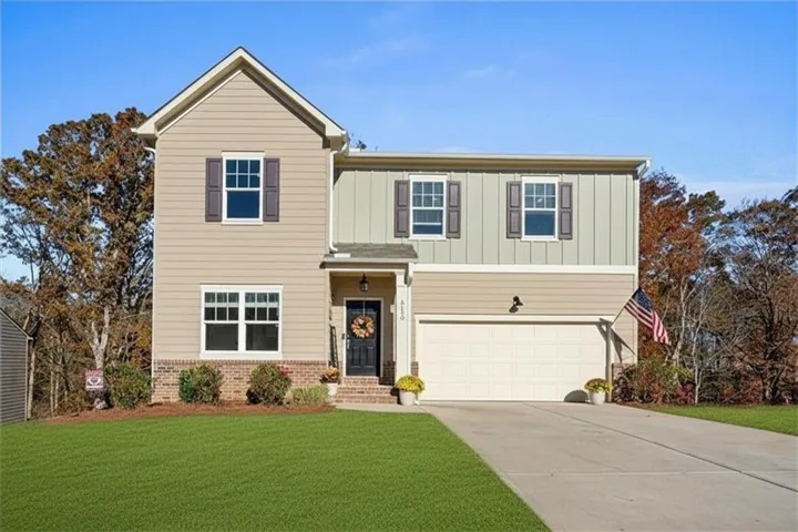 Two-story home featuring a combination of horizontal siding and vertical board and batten siding