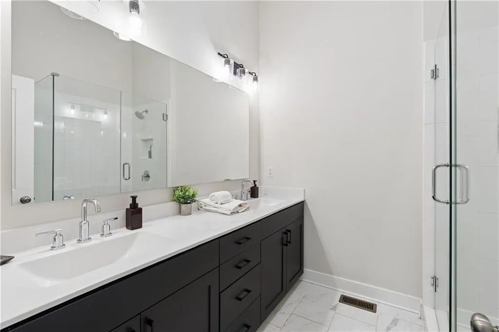 Double vanity featuring integrated sinks and polished chrome fixtures