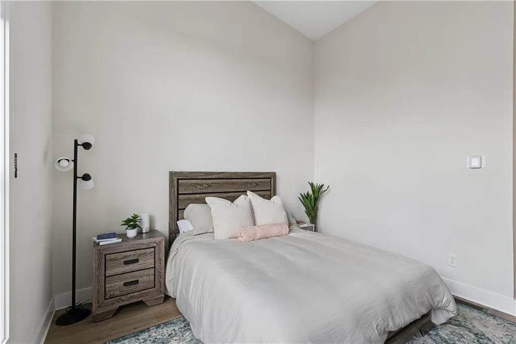 Light-toned walls with contrasting baseboards, complemented by wood-finish flooring