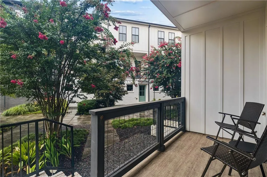 Private balcony featuring wood-finish flooring and a contemporary metal railing