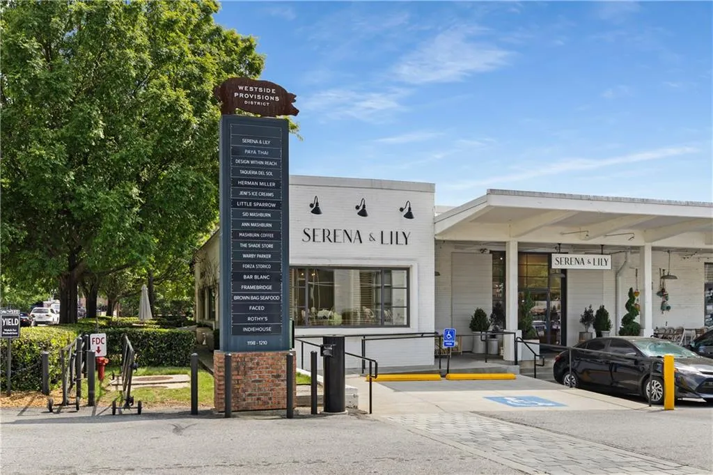 Commercial property featuring a prominent multi-tenant sign with brick base