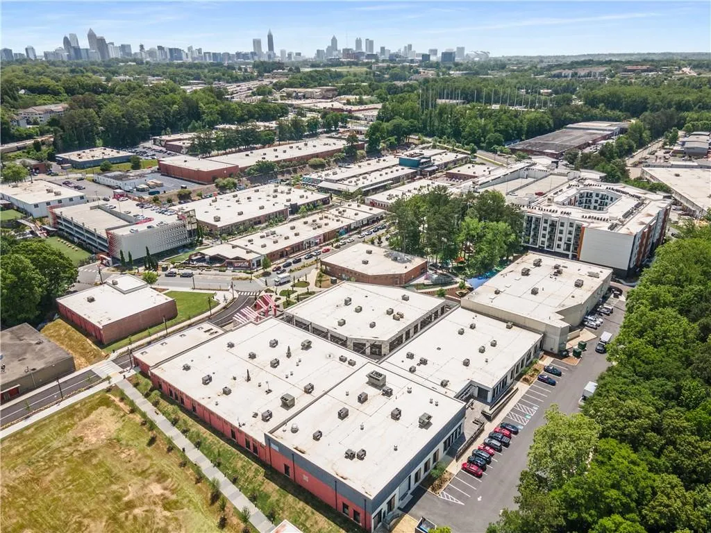 Aerial perspective showcasing a commercial district with multiple buildings under a clear sky