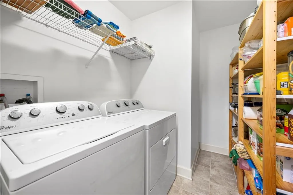 Laundry area with independent washer and dryer and baseboards