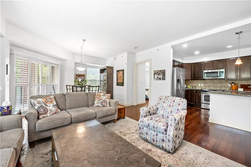 Living room with dark wood-style floors, baseboards, and recessed lighting