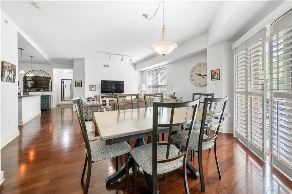 Dining area featuring dark wood finished floors, baseboards, and track lighting
