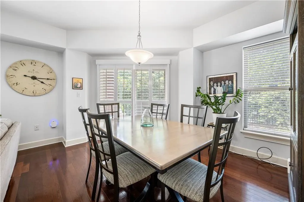 Dining space featuring dark wood-style flooring and baseboards