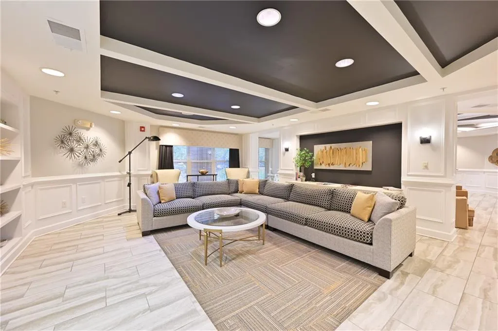 Living area featuring a decorative wall and wainscoting