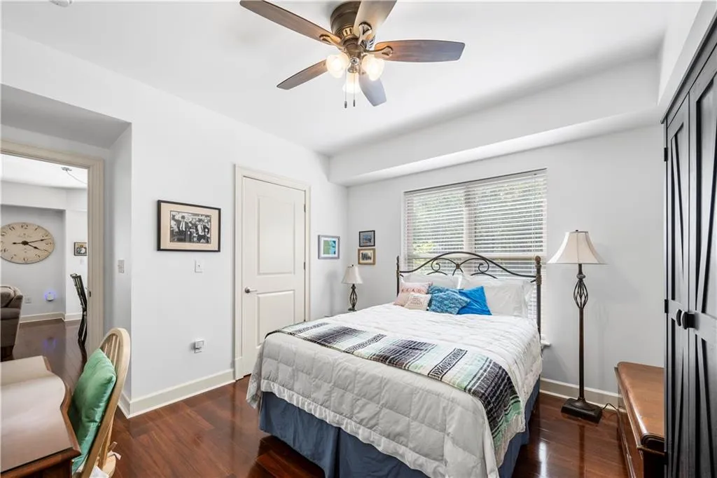 Bedroom featuring baseboards, wood finished floors, ceiling fan, and a closet