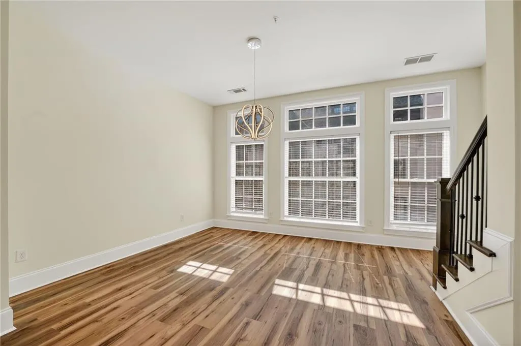 Unfurnished dining area featuring light wood-style floors and baseboards