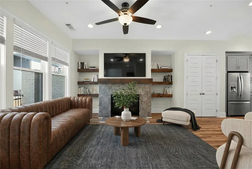 Living area featuring wood finished floors, a fireplace, recessed lighting, and ceiling fan
