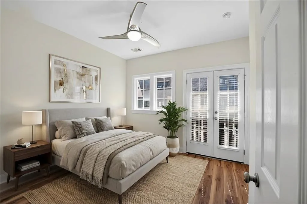 Bedroom featuring french doors, access to outside, wood finished floors, and a ceiling fan