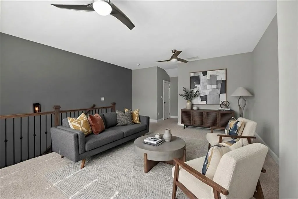 Living room with a ceiling fan and carpet flooring