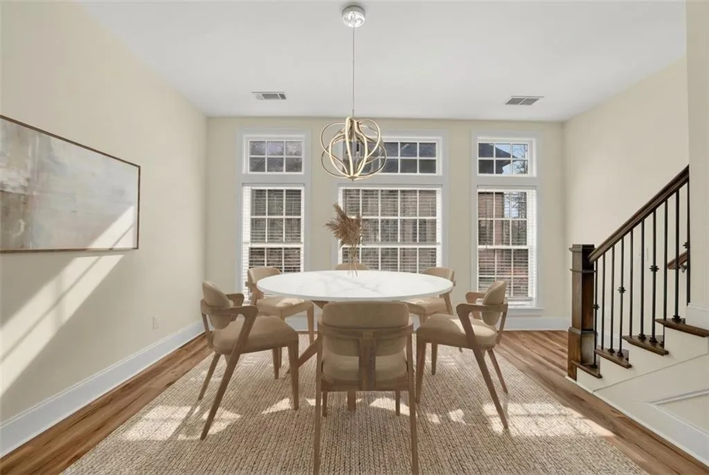 Dining room featuring stairs and light wood-style floors