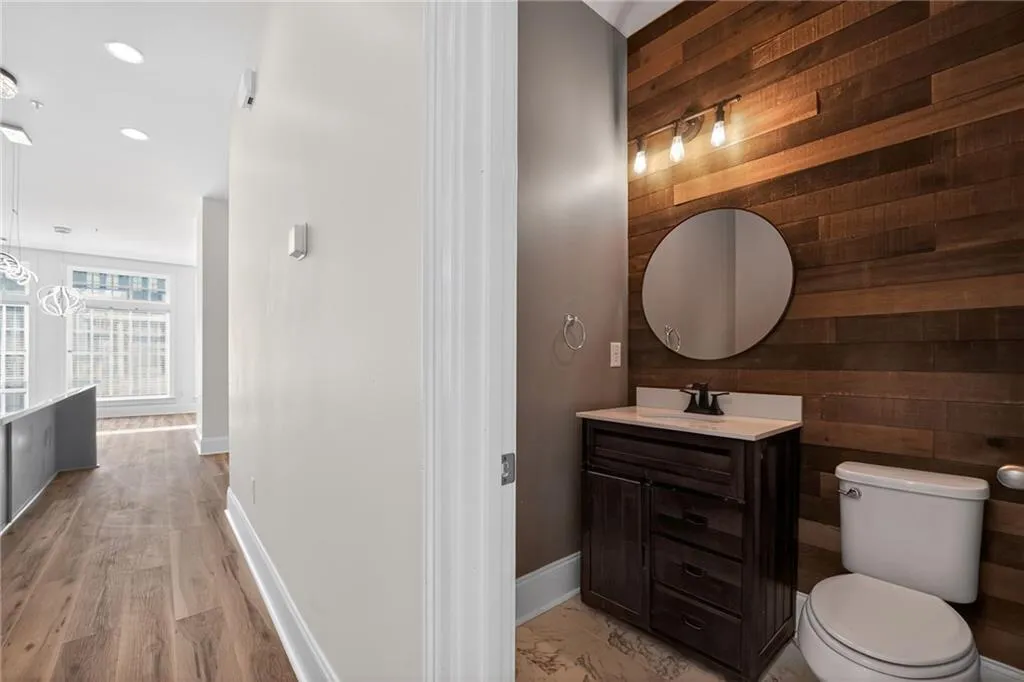 Half bathroom with wooden walls and vanity