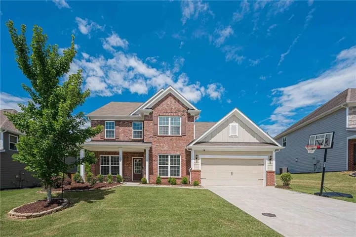 Two-story brick façade residence with a covered porch entry