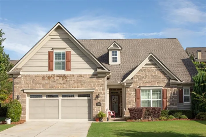 Stone and siding exterior with a multi-gabled roofline