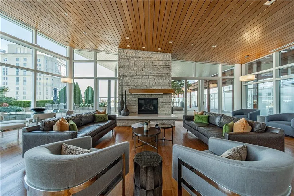 Building lobby with expansive windows, wooden ceiling, a view of city, and a towering ceiling