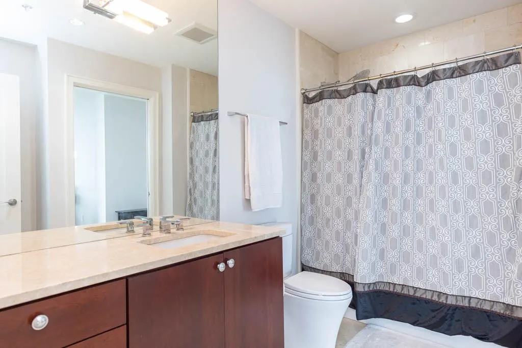 Full bathroom featuring vanity, recessed lighting, and shower / bath combo with shower curtain