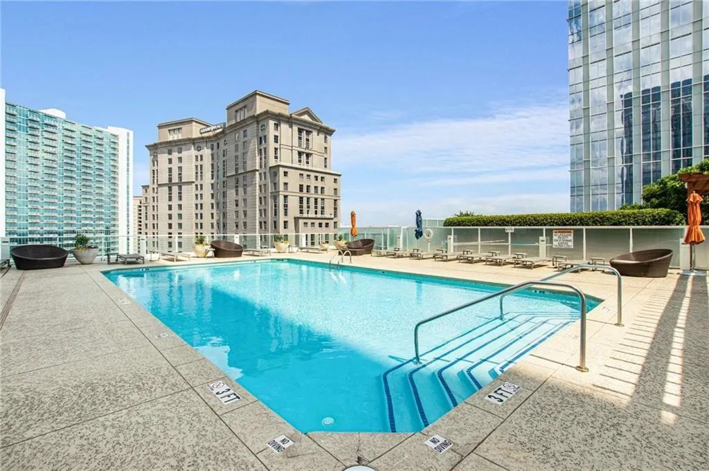 Community pool with a patio