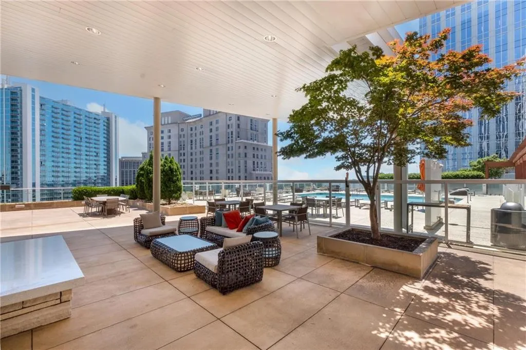 View of patio with outdoor dining space and a city view