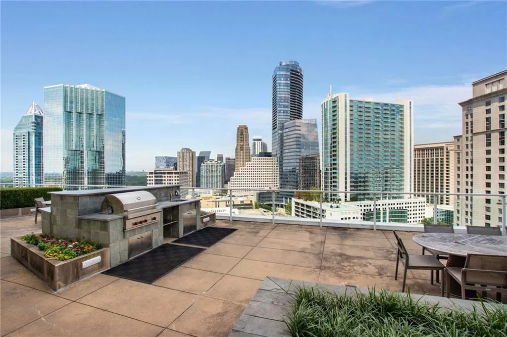 View of patio featuring exterior kitchen and a skyline view